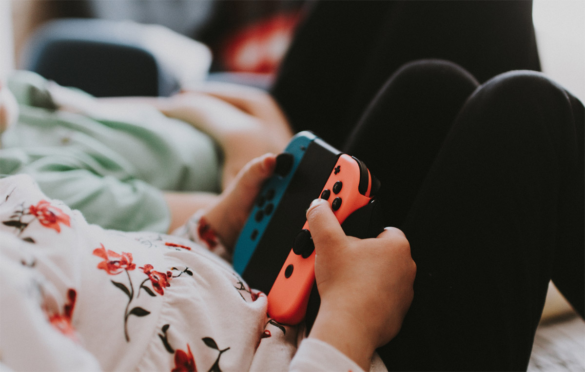 child holding Nintendo Switch controller