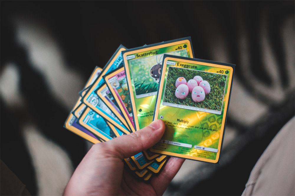 a hand holding trading cards