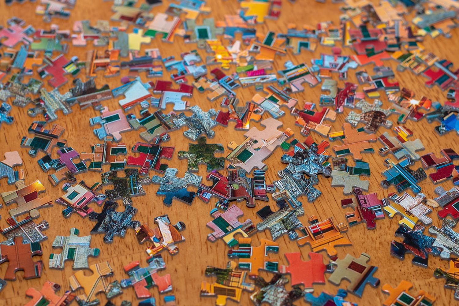 colorful jigsaw puzzle pieces on table colorful jigsaw puzzle pieces on table