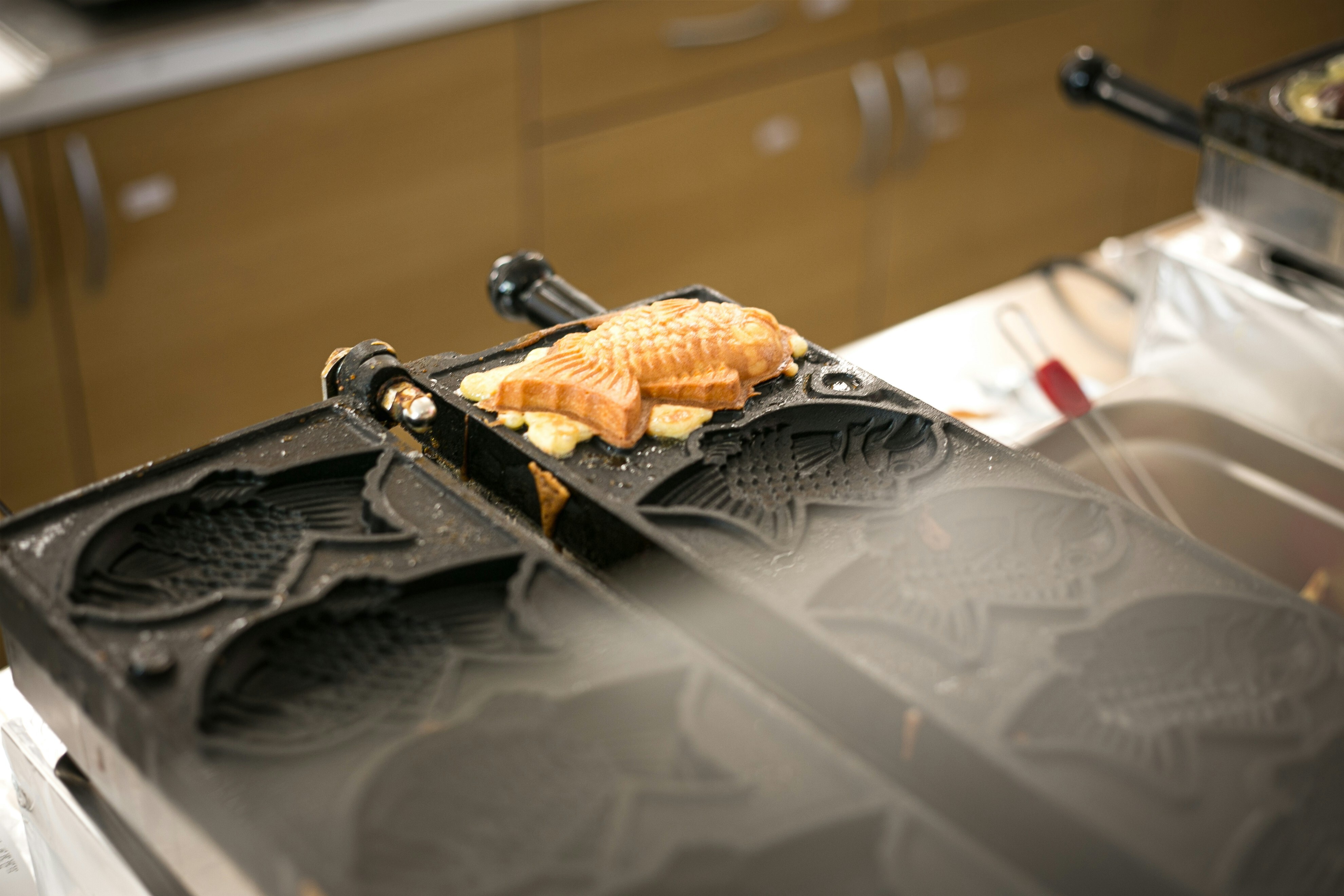 A single taiyaki still on a griddle