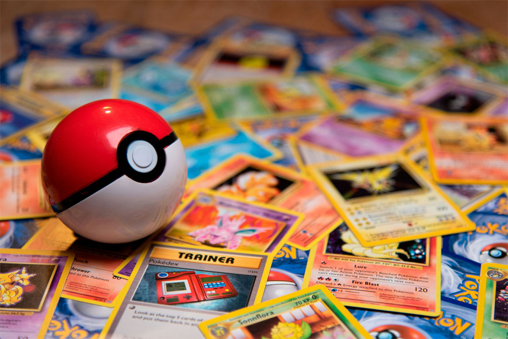 a pokeball on top of a pile of pokemon cards