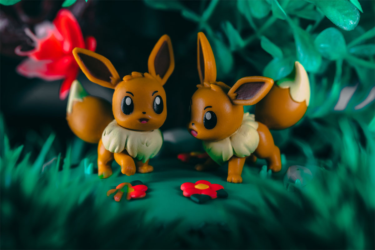 two small Pokemon toys in fake grass